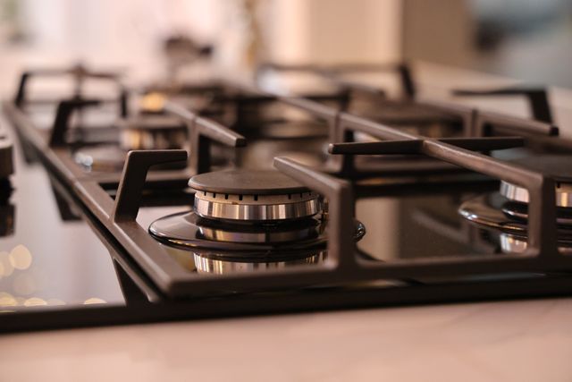 Close-up of a modern stainless steel gas stove top, ideal for contemporary kitchens and cooking environments.